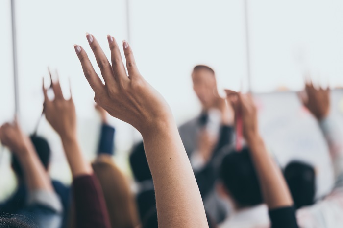 People resising their hands in a classroom